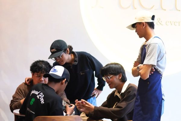 Group of friends sitting at the table in Ruema Cafe, enjoying a casual cafe gathering